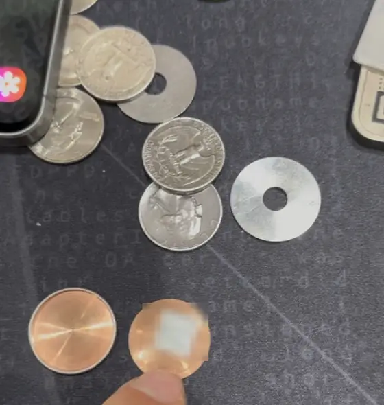 Copper discs and steel washers used as DIY stamping blanks (words blurred)