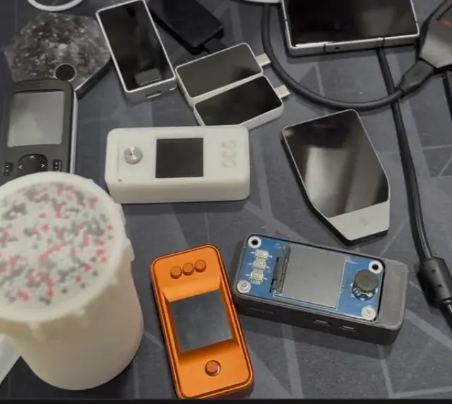Lineup: bead entropy shaker, white and orange DIY signers, a Waveshare 1.3" LCD HAT build (the classic SeedSigner layout), a Trezor-shaped device
