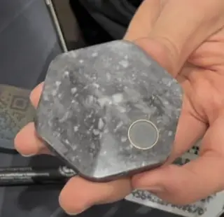 Bitkey by Block: hexagonal hardware key; the round metal pad is the fingerprint sensor